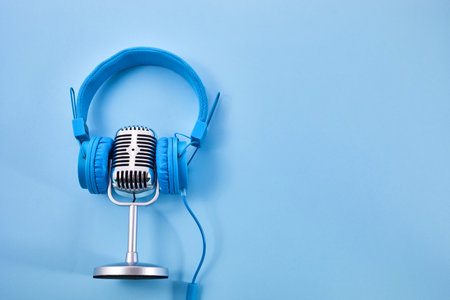 World music day concept. Stereo headphone and a microphone on a blue backgroundの写真素材