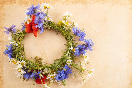 Wreath of chamomile flower on vintage background. Midsummer holiday backgroundの写真素材