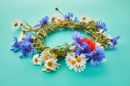 Wreath of chamomile flower on green background. Midsummer holiday backgroundの写真素材