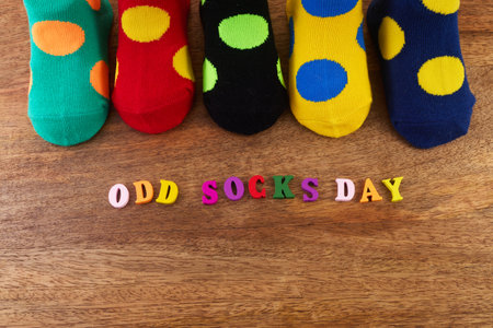 Odd Socks Day. Day lost socks, lonely socks on wooden background.の写真素材