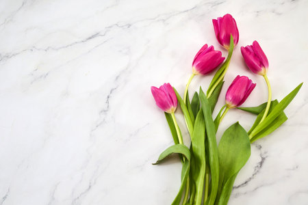 Bouquet of pink tulips on marble background. Mothers day, Valentines Day, Birthday celebration concept.の写真素材