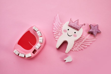 Happy Tooth Fairy Day. Children tooth fairy. Cute tooth with wings, a crown and a magic wandの写真素材