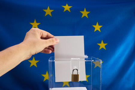 European Election Vote Concept. Hand placing a voting ballot into a clear boxの写真素材