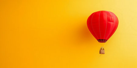 Red Hot Air Balloon Against Yellow Backgroundの素材