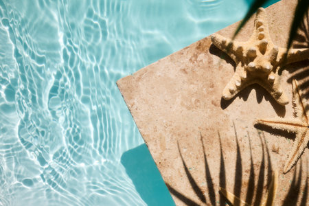 A serene poolside with starfish on sunlit tiles, capturing the essence of summer.の写真素材