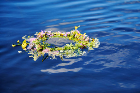 Flower Wreath on Water River. Ligo, Ivan Kupala. Midsummer Solstice Holiday concept