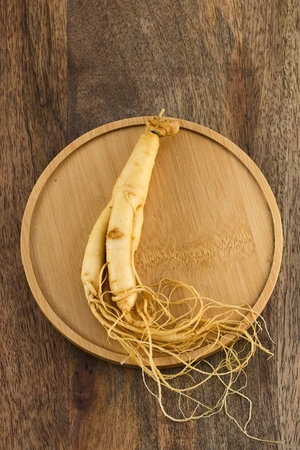 Ginseng Root on Wooden Plateの写真素材
