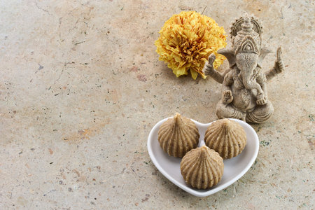 Ganesh Chaturthi Festival. Ganesha statue with modak sweets