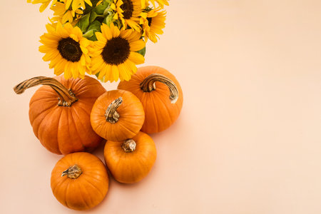 A cozy autumn scene featuring pumpkins and sunflowers. Perfect for fall celebrations and decoration.の写真素材