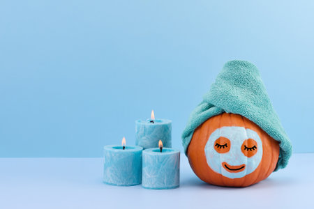 Pumpkin Spa Day. A pumpkin with a towel and face maskの写真素材