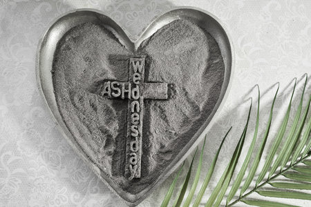 Ash Wednesday Symbol. Heart-shaped ash tray with cross and palm leaf