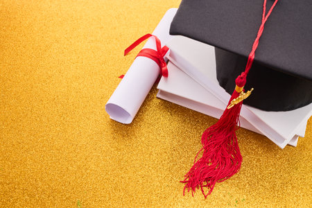 Graduation Celebration. A graduation cap, diploma, and booksの写真素材