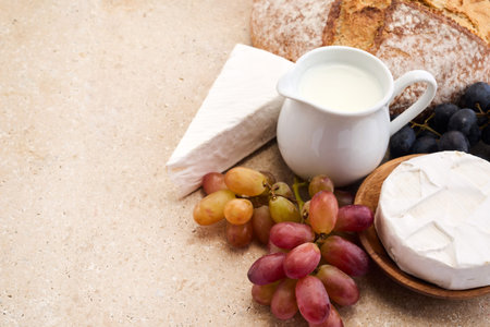 Jewish holiday Shavuot concept. Grains, milk and cheese on travertini stone backgroundの写真素材