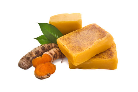 Turmeric Soap. Yellow turmeric soap bars with fresh turmeric roots on a white background.の写真素材