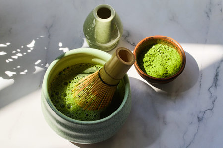 Ceremonial Matcha Setup. Traditional matcha tea set with powder, bamboo whisk