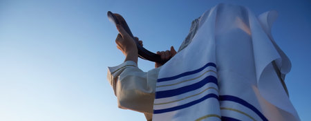 Jewish man blowing the Shofar horn of Rosh Hashanah - New Year.の写真素材