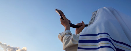 Jewish man blowing the Shofar horn of Rosh Hashanah. New Year.