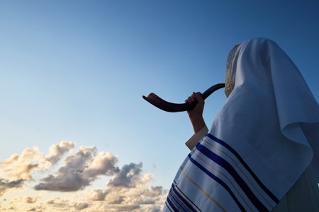 Jewish man blowing the Shofar horn of Rosh Hashanah - New Year. Horizon Ritualの写真素材