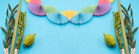 Colorful Sukkot Composition. Festive Sukkot arrangement with lulav, etrog, and vibrant paper decorationsの写真素材