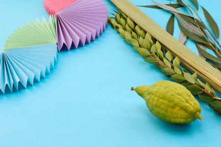 Colorful Sukkot Composition. Festive Sukkot arrangement with lulav, etrog, and vibrant paper decorationsの写真素材