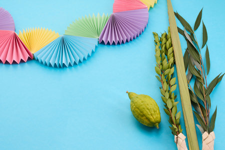 Colorful Sukkot Composition. Festive Sukkot arrangement with lulav, etrog, and vibrant paper decorationsの写真素材