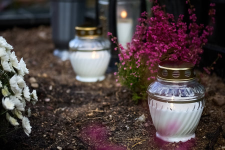 Day of the dead. Cemetery Candles. Candlelit Memorial Garden. A serene garden scene with lit candles and vibrant flowersの写真素材