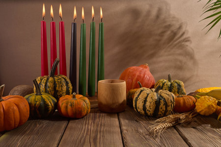 Kwanzaa. African holiday Kwanzaa with decoration of seven candles and pumpkinsの写真素材