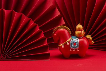 Lunar New Year 2026. New Year background. Red Paper Fans and Horse Figurineの写真素材