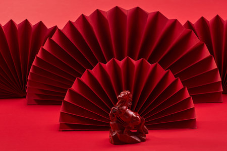 Lunar New Year 2026. New Year background. Red Paper Fans and Horse Figurineの写真素材