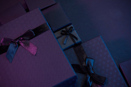 Elegant Gift Boxes. Stylish gift boxes in deep purple and blue tones with satin ribbonsの写真素材