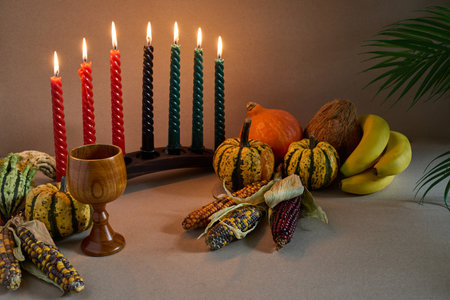 Festive Kwanzaa Setting. A warm Kwanzaa scene with a kinara, fruits, and vegetablesの写真素材