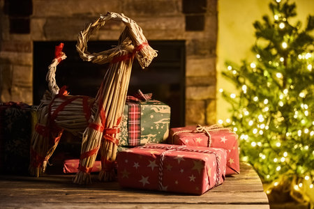 Festive Christmas Scene. Cozy fireplace scene with straw goatの写真素材