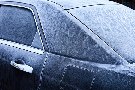 Frosted Car. Close-up of a car covered in frost, showcasing intricate ice patternsの写真素材