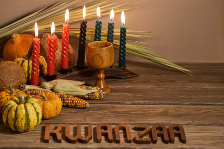 Kwanzaa Celebration Setup. A festive Kwanzaa display with candles, fruits, and decorative elementsの写真素材