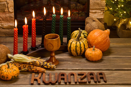 Kwanzaa Celebration. Festive Kwanzaa setup with candles, corn, and pumpkinsの写真素材
