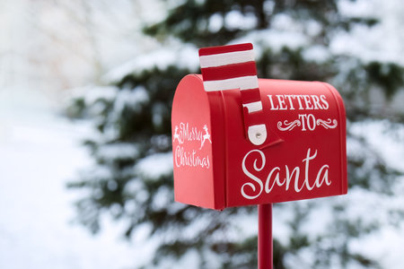 Santas Mailbox in Snowy Scene. Red mailbox for letters to Santa, set in a snowy winter backgroundの写真素材