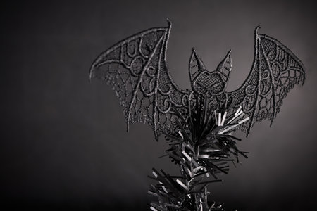 Gothic Bat Tree Topper. A dark, gothic bat detail on a tree.の写真素材