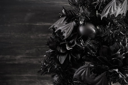 Gothmas. Gothic Holiday Decor. Dark festive wreath with black bats and flowers creating a mysterious...