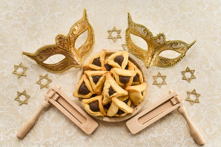 Purim celebration with hamantaschen, masks, graggers, and star of davidの写真素材