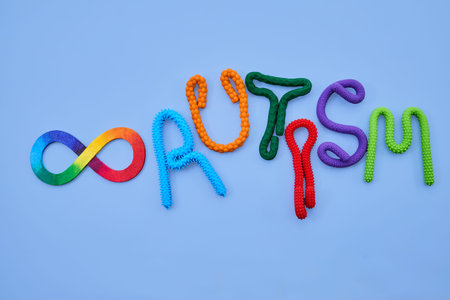 Neurodiversity infinity symbol and autism word on blue background