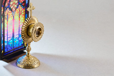 Monstrance for eucharistic adoration with stained glass background