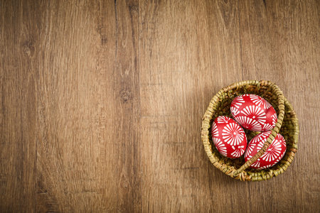 Red easter eggs with floral pattern in basket