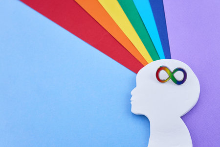Neurodiversity concept with rainbow infinity symbol on white head silhouette