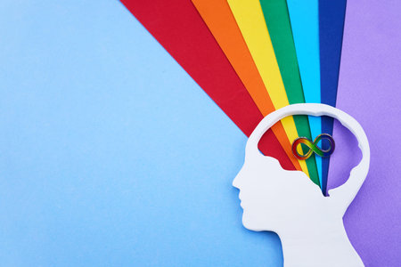 Human head silhouette with rainbow infinity symbol for neurodiversity