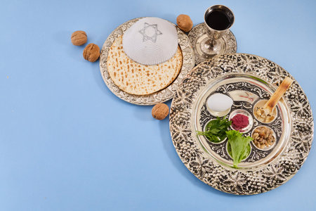 Passover seder plate with matzah, kippah, and wine
