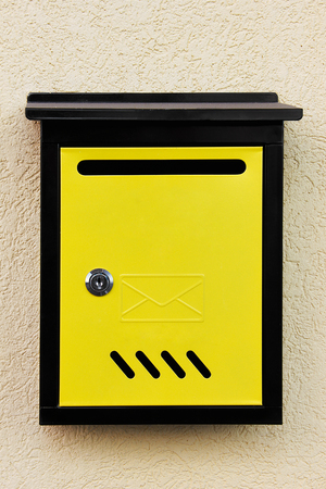 Yellow mailbox on the wallの写真素材