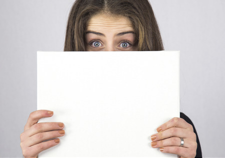 woman holding empty posterの写真素材