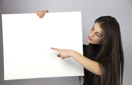 woman holding empty posterの写真素材