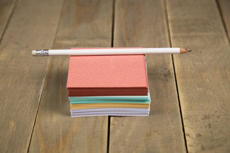note on wood background with pencil