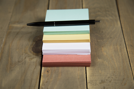 note on wood background with penの写真素材